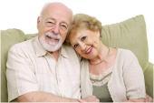 Image of happy retired couple on couch.